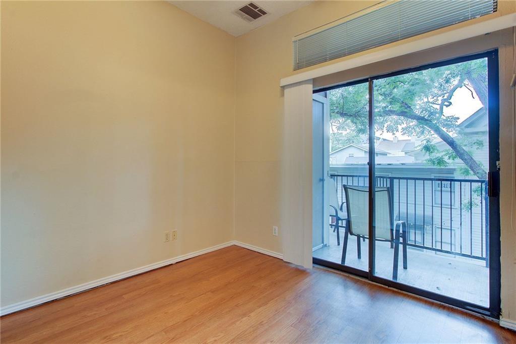 2802 Nueces Street, Unit 206 Austin, TX 78705 - Photo 13 of 14 a view of empty room with wooden floor and fan