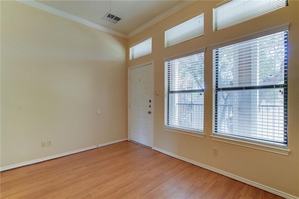 2802 Nueces Street, Unit 206 Austin, TX 78705 - Photo 6 of 14 a view of an empty room with wooden floor and a window