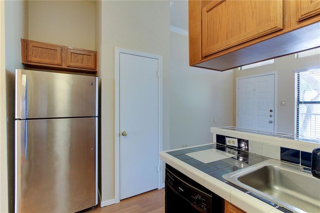 2802 Nueces Street, Unit 206 Austin, TX 78705 - Photo 9 of 14 a kitchen with stainless steel appliances granite countertop a refrigerator a sink and dishwasher
