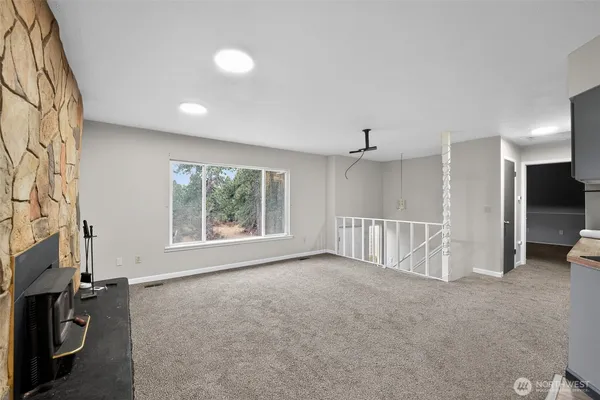 a large kitchen with a large counter top stainless steel appliances and wooden floor