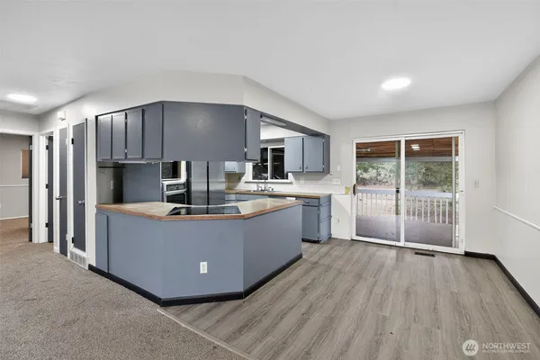 a kitchen with wooden floors and appliances