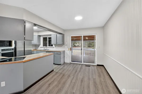 a large kitchen with stainless steel appliances kitchen island a large counter top and a stove