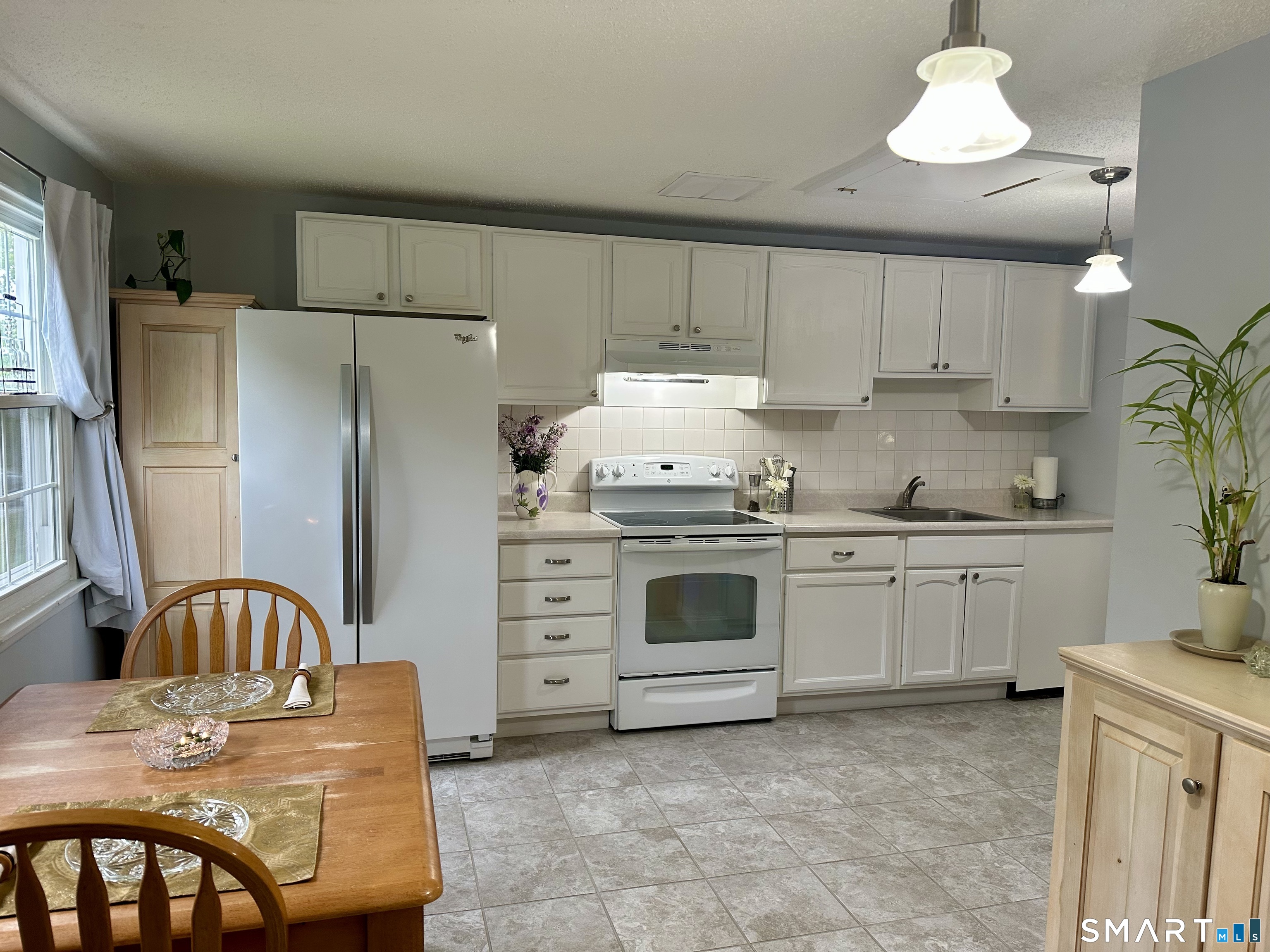 2 Lakeside Drive, Unit M Ledyard, CT 06339 - Photo 6 of 38 a kitchen with stainless steel appliances granite countertop a stove refrigerator sink and cabinets