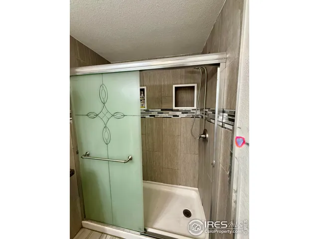 a bathroom with a shower and a sink