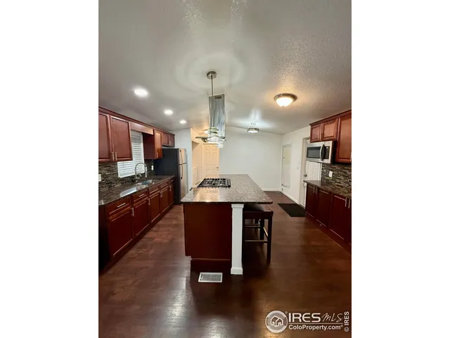 a large kitchen with a table and chairs