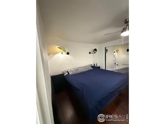 a en suite bathroom with a granite countertop sink and a mirror