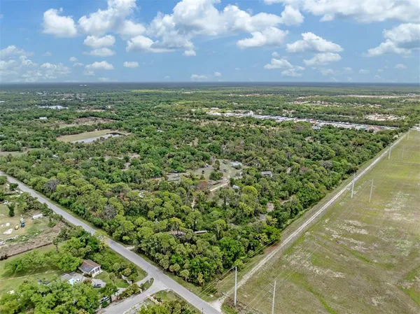 a view of a big yard with lots of green space