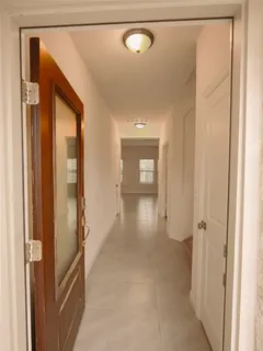 a view of a hallway with wooden shelves