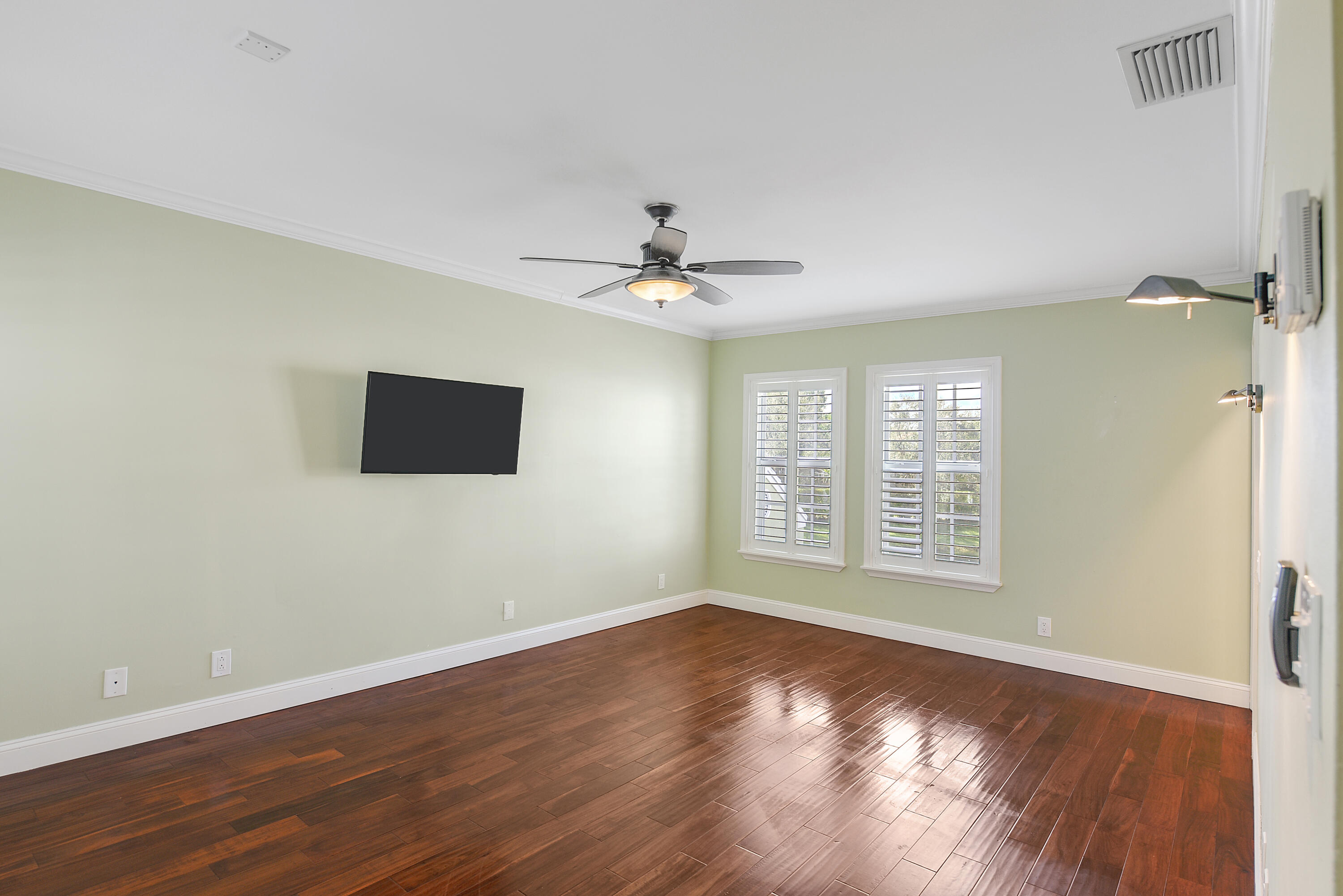 23325 Drayton Drive Boca Raton, FL 33433 - Photo 22 of 44 a view of an empty room with wooden floor and a window
