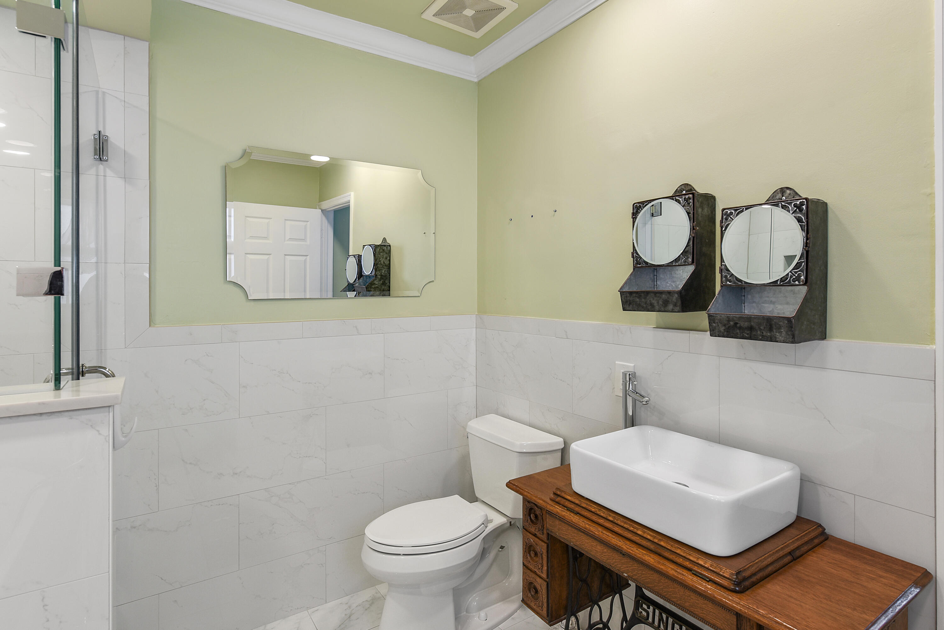 23325 Drayton Drive Boca Raton, FL 33433 - Photo 26 of 44 a bathroom with a toilet a sink and mirror