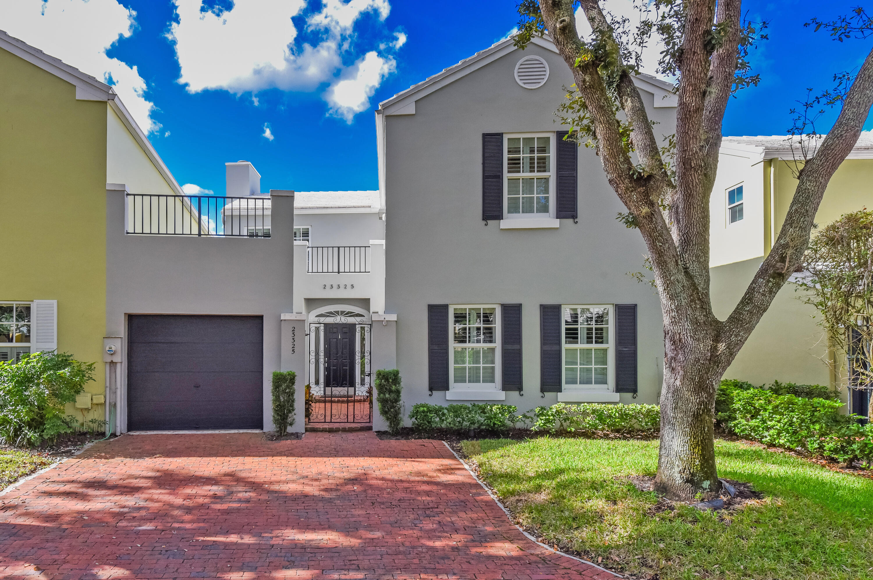 23325 Drayton Drive Boca Raton, FL 33433 - Photo 43 of 44 a front view of a house with a yard and garage