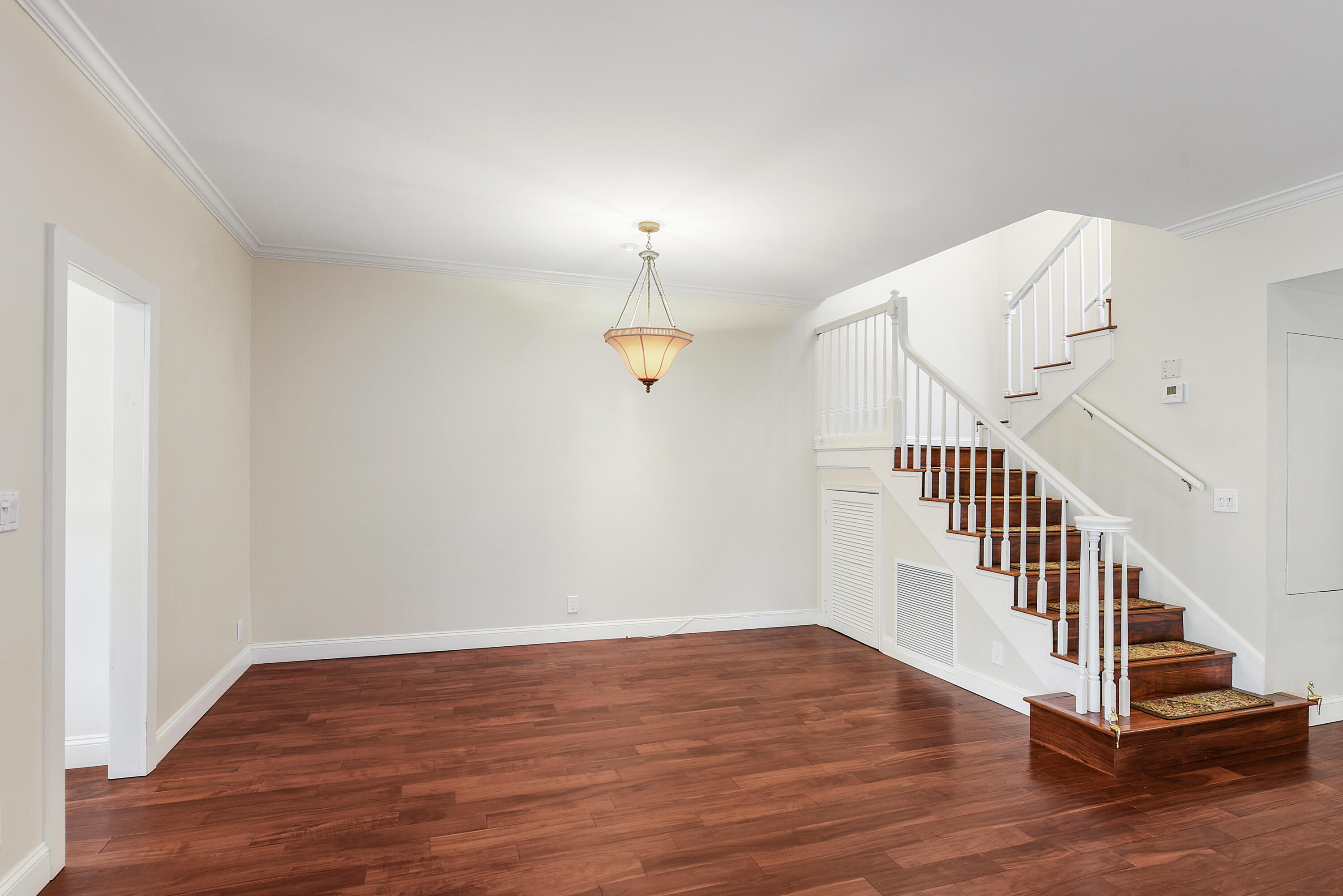 23325 Drayton Drive Boca Raton, FL 33433 - Photo 6 of 44 a view of a hallway with wooden floor and staircase