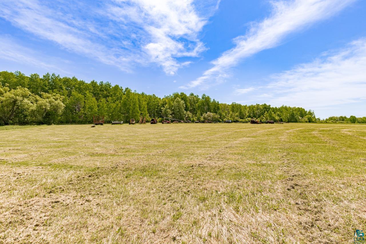 6606 Metso Road Kettle River, MN 55757 - Photo 49 of 84 Expansive open field with a lush tree line bordering the property