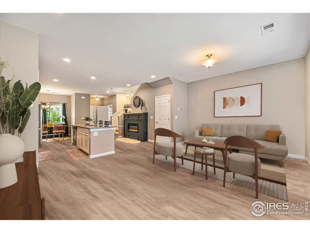 a living room with furniture and kitchen view