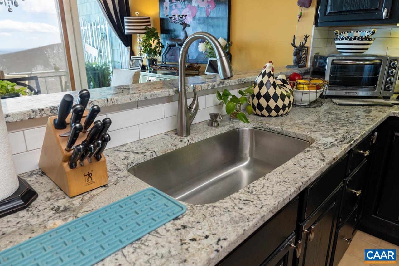 1707 High Ridge Wintergreen, VA 22967 - Photo 15 of 50 a sink with granite countertop a sink and a stove