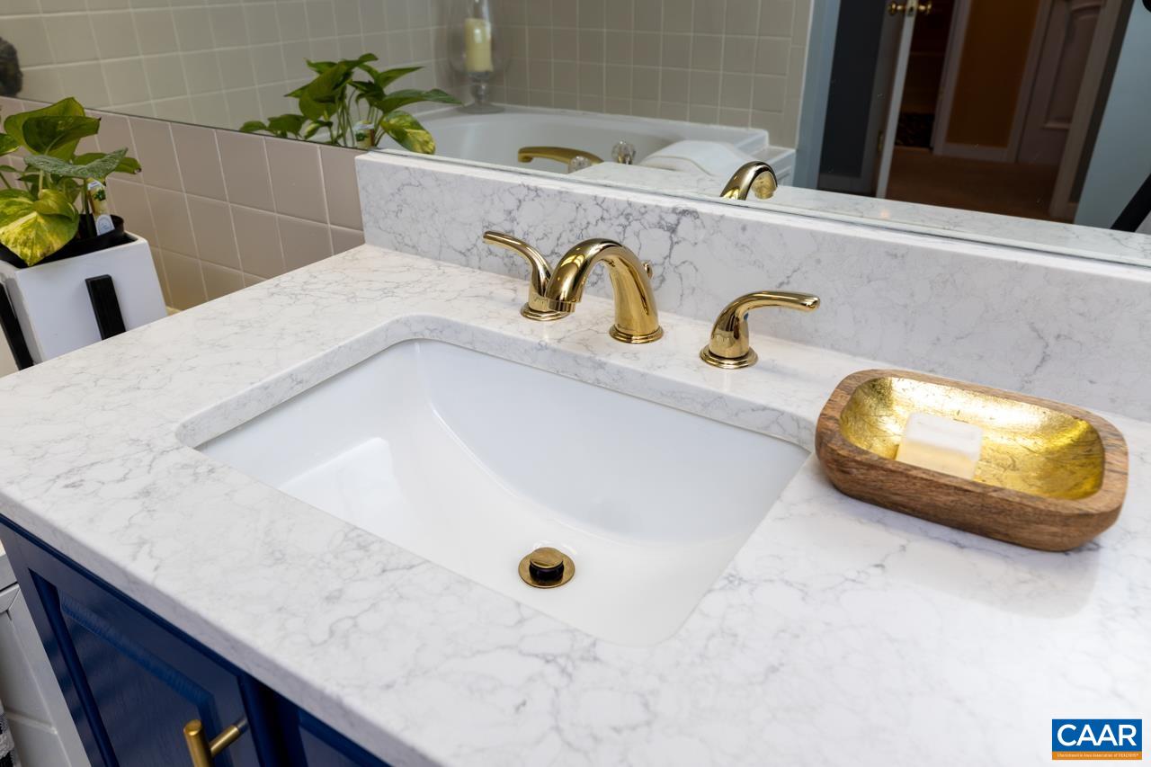 1707 High Ridge Wintergreen, VA 22967 - Photo 28 of 50 a bathroom with a granite countertop sink a mirror and vanity