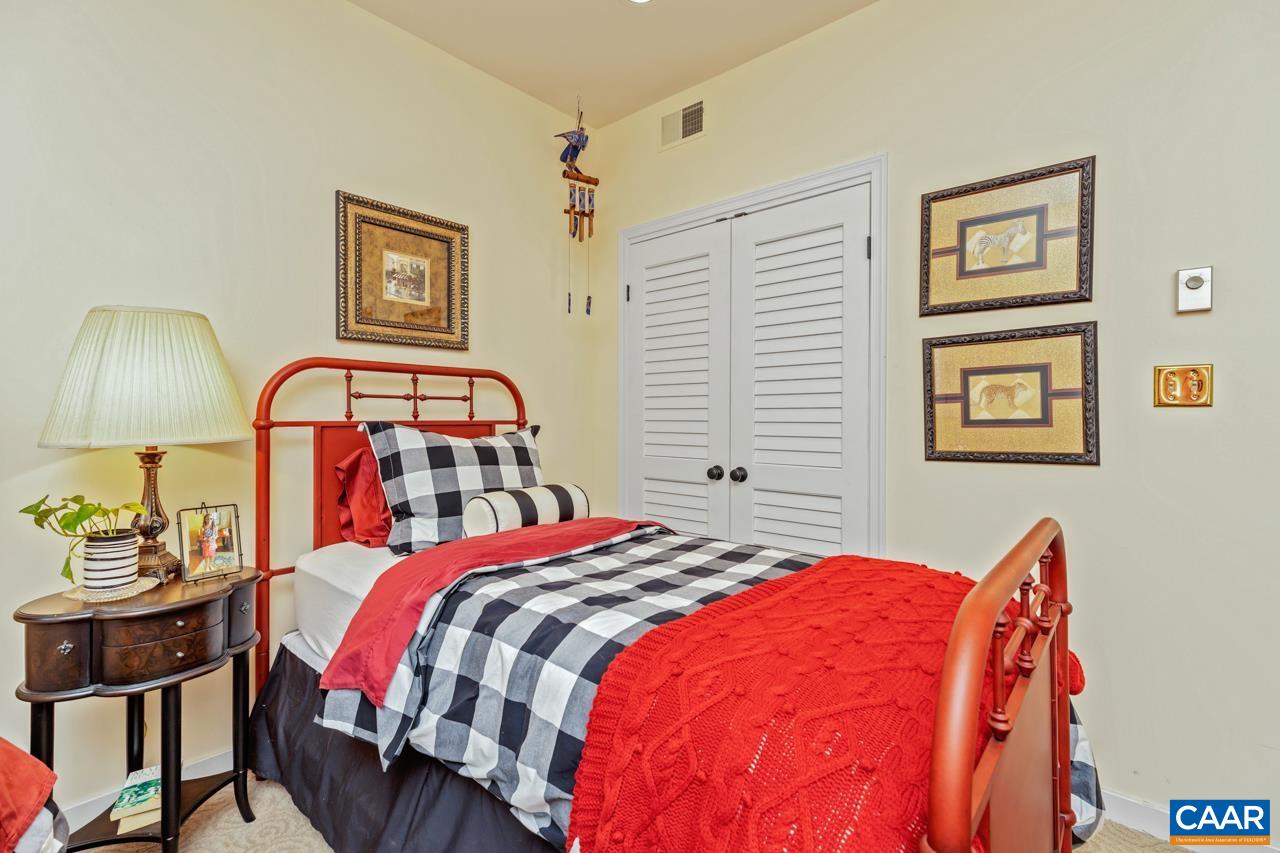 1707 High Ridge Wintergreen, VA 22967 - Photo 34 of 50 a bedroom with a bed a painting on the wall and a lamp on dresser