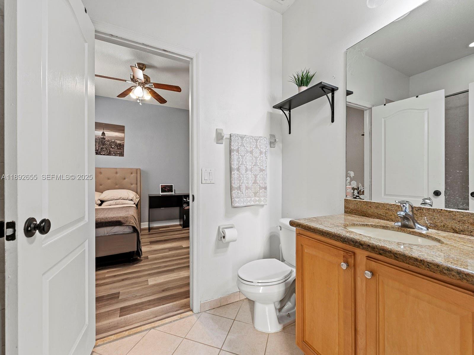 11279 Southwest 238th Street Homestead, FL 33032 - Photo 13 of 40 a bathroom with a granite countertop sink toilet and shower