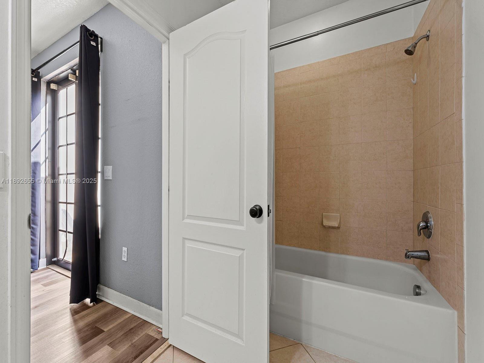 11279 Southwest 238th Street Homestead, FL 33032 - Photo 14 of 40 a bathroom with a bathtub and a shower