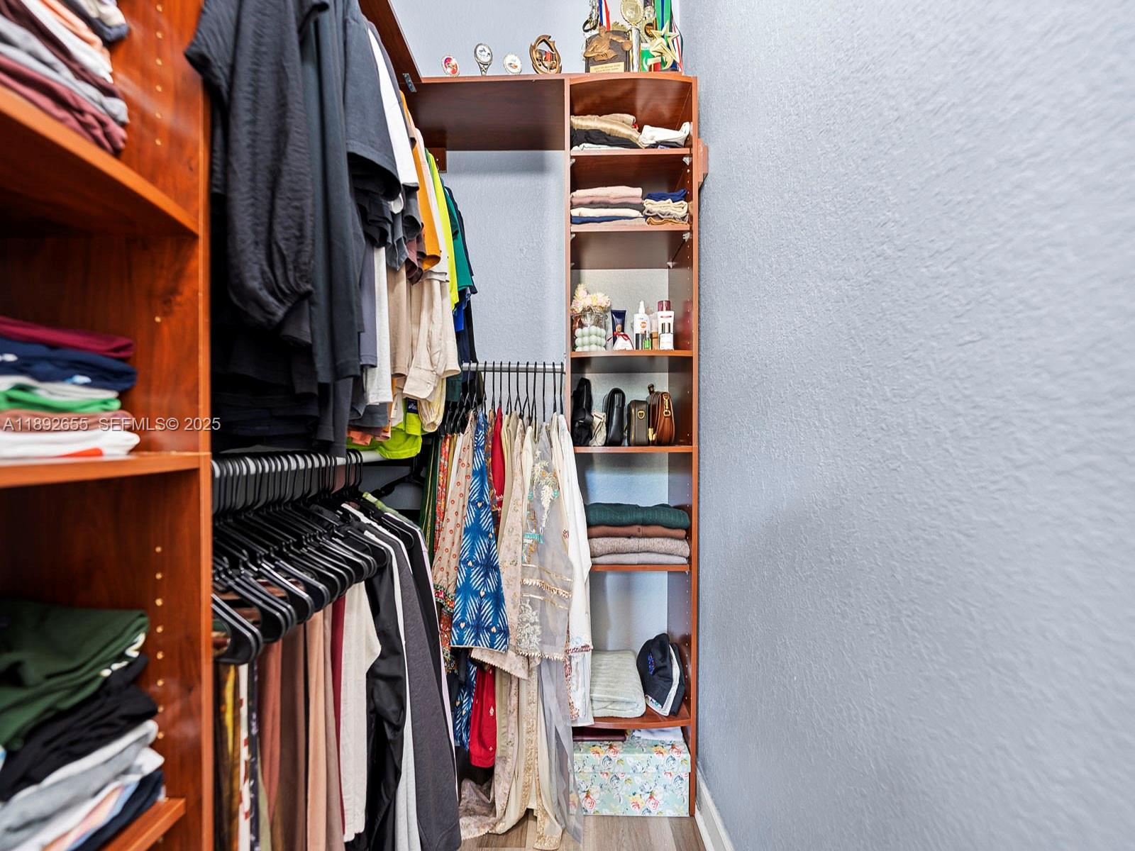 11279 Southwest 238th Street Homestead, FL 33032 - Photo 17 of 40 a view of walk in closet with clothes and shoes