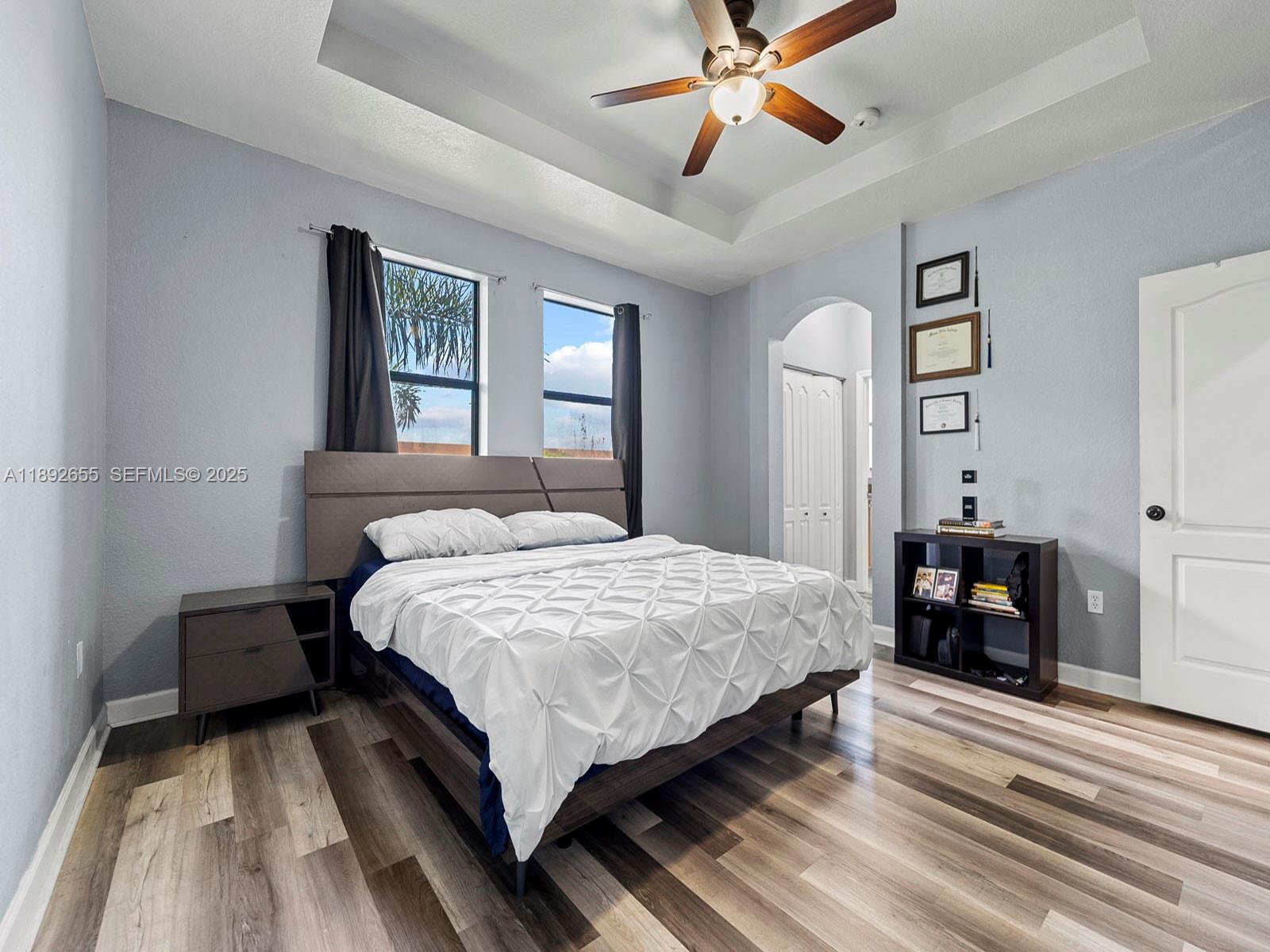 11279 Southwest 238th Street Homestead, FL 33032 - Photo 24 of 40 a bedroom with a bed and a chandelier