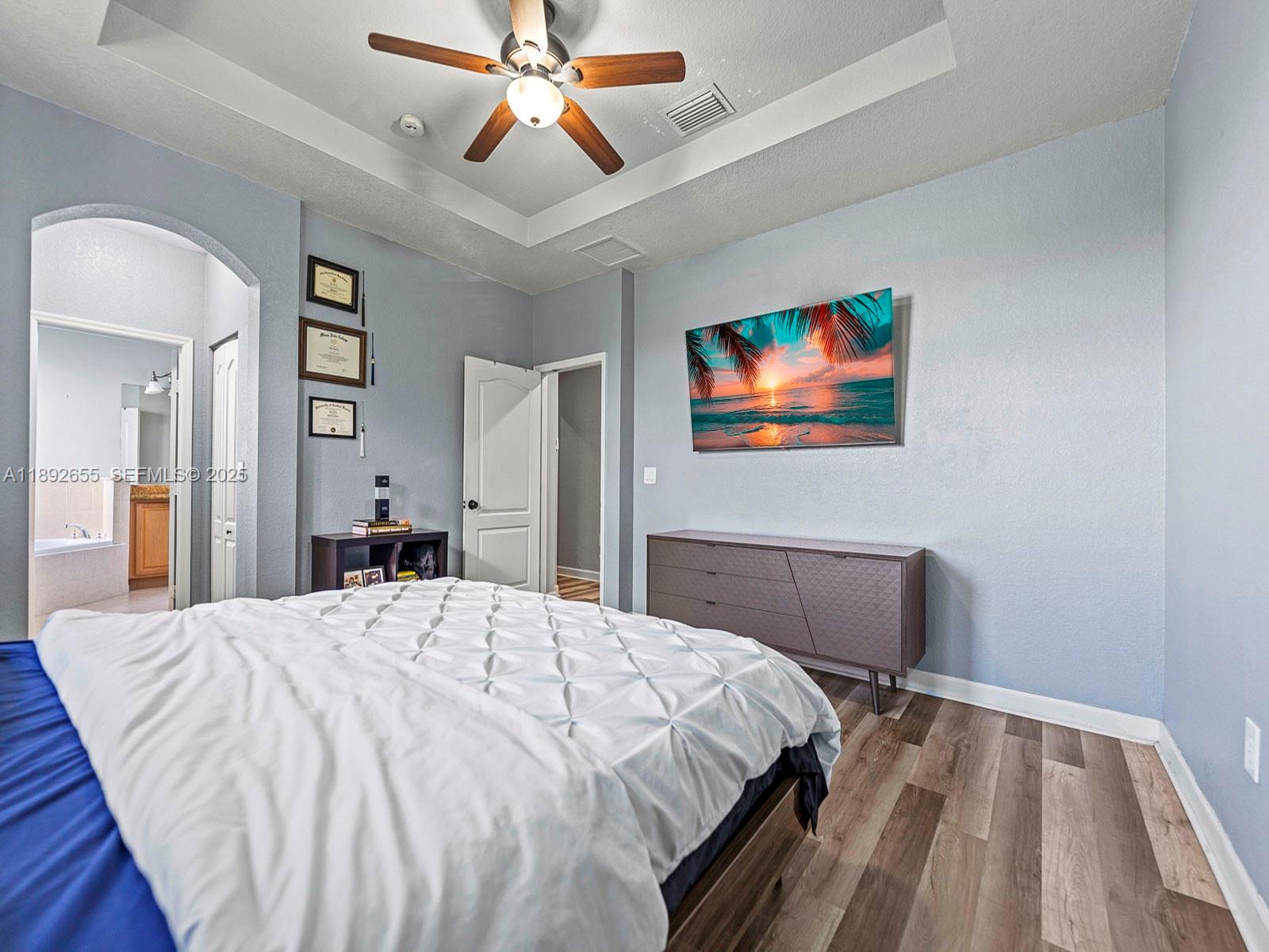 11279 Southwest 238th Street Homestead, FL 33032 - Photo 25 of 40 a bedroom with a bed and a chandelier