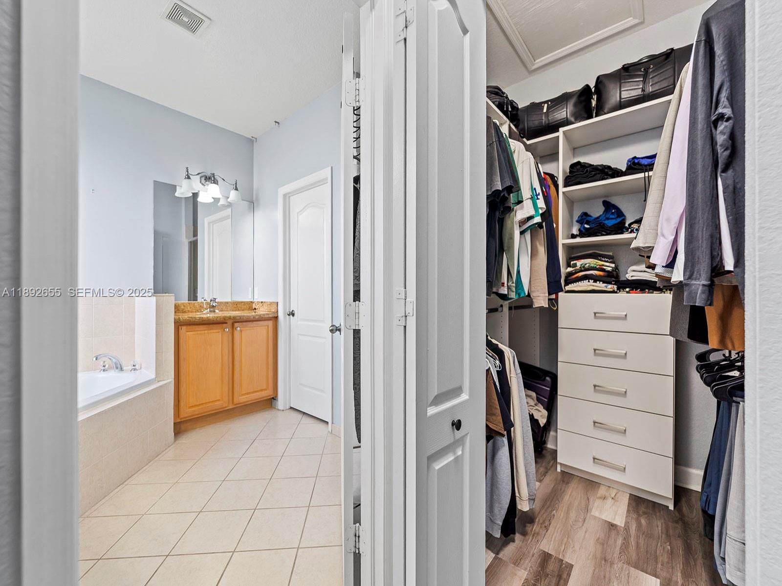 11279 Southwest 238th Street Homestead, FL 33032 - Photo 27 of 40 a view of walk in closet with clothes and shoes