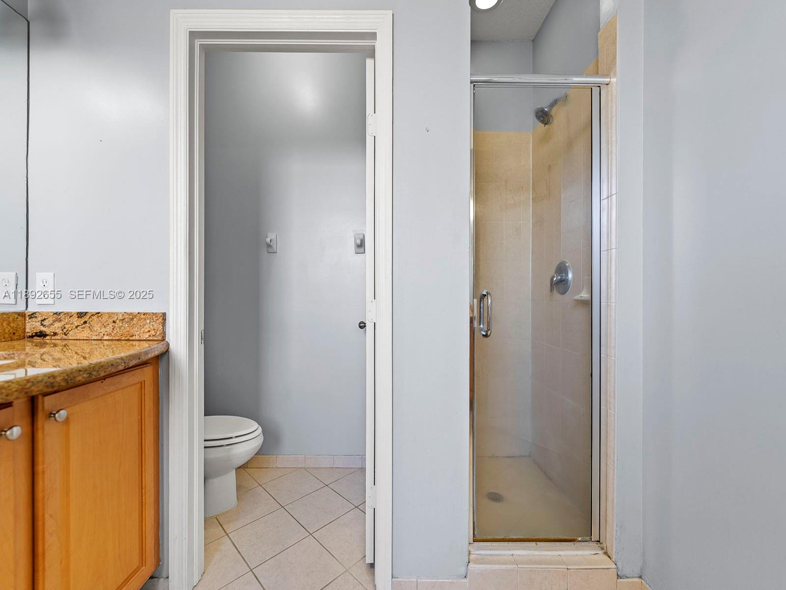 11279 Southwest 238th Street Homestead, FL 33032 - Photo 29 of 40 a bathroom with a granite countertop sink toilet and shower