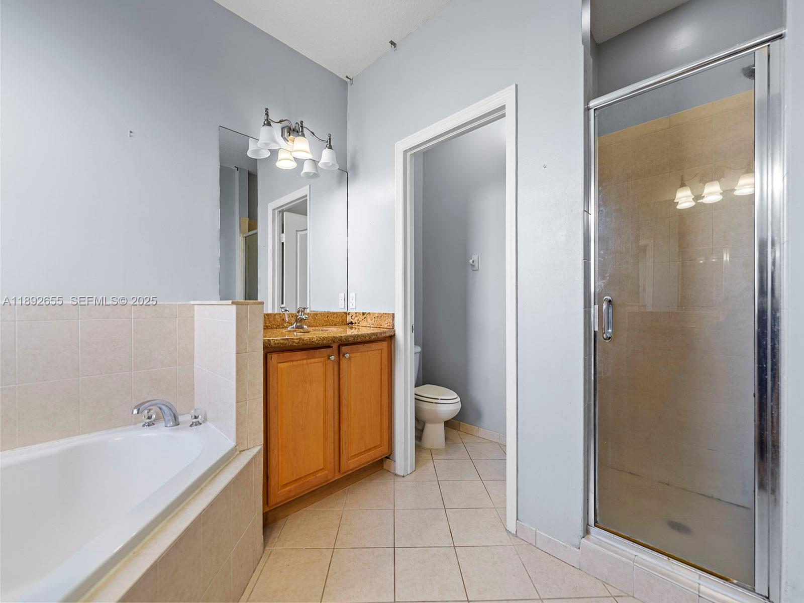 11279 Southwest 238th Street Homestead, FL 33032 - Photo 30 of 40 a bathroom with a bathtub a toilet and a shower