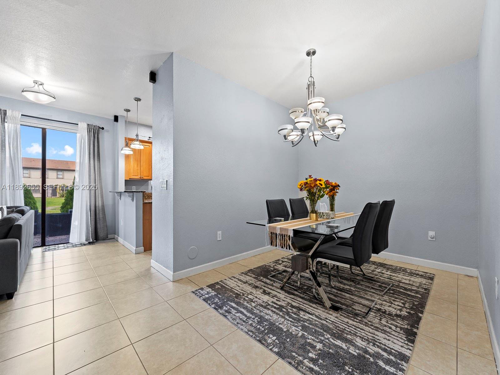 11279 Southwest 238th Street Homestead, FL 33032 - Photo 3 of 40 a workspace with furniture and chandelier