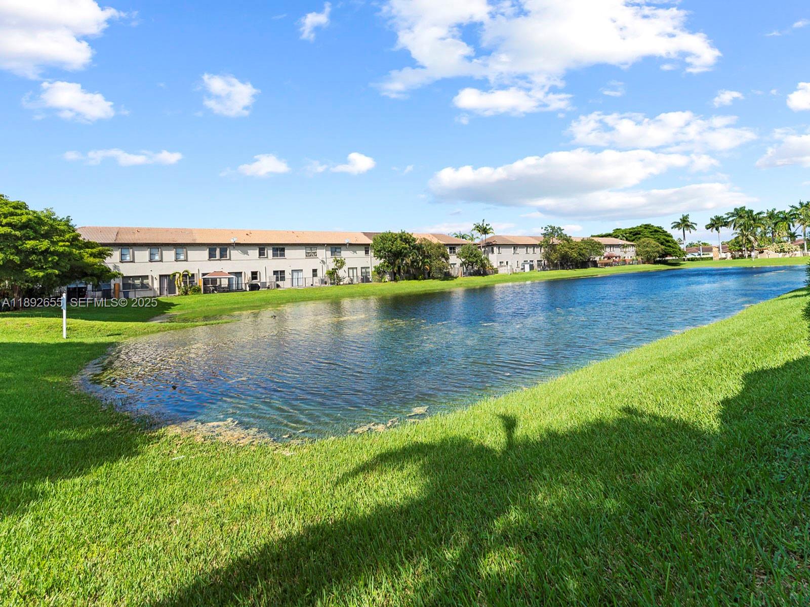 11279 Southwest 238th Street Homestead, FL 33032 - Photo 32 of 40 a view of a lake with houses in the back