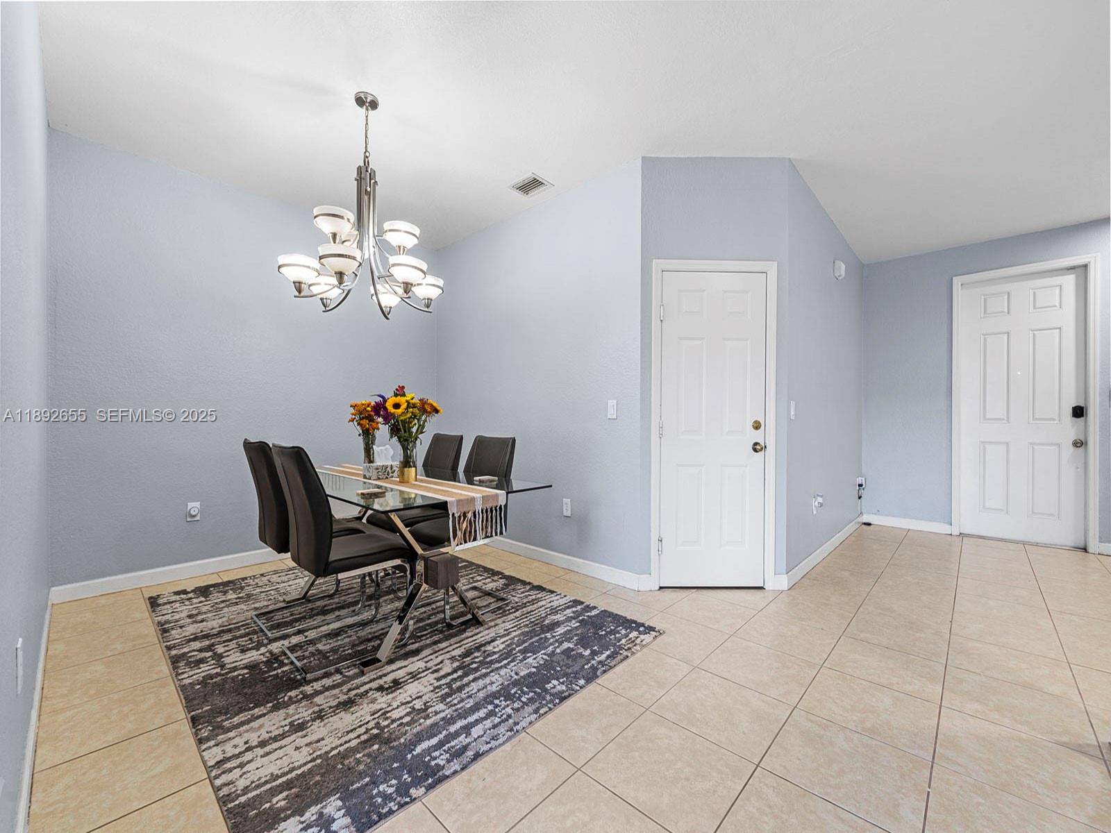11279 Southwest 238th Street Homestead, FL 33032 - Photo 4 of 40 a work room with furniture and chandelier
