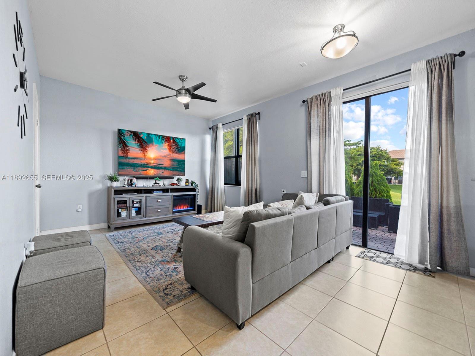 11279 Southwest 238th Street Homestead, FL 33032 - Photo 5 of 40 a living room with furniture and a flat screen tv