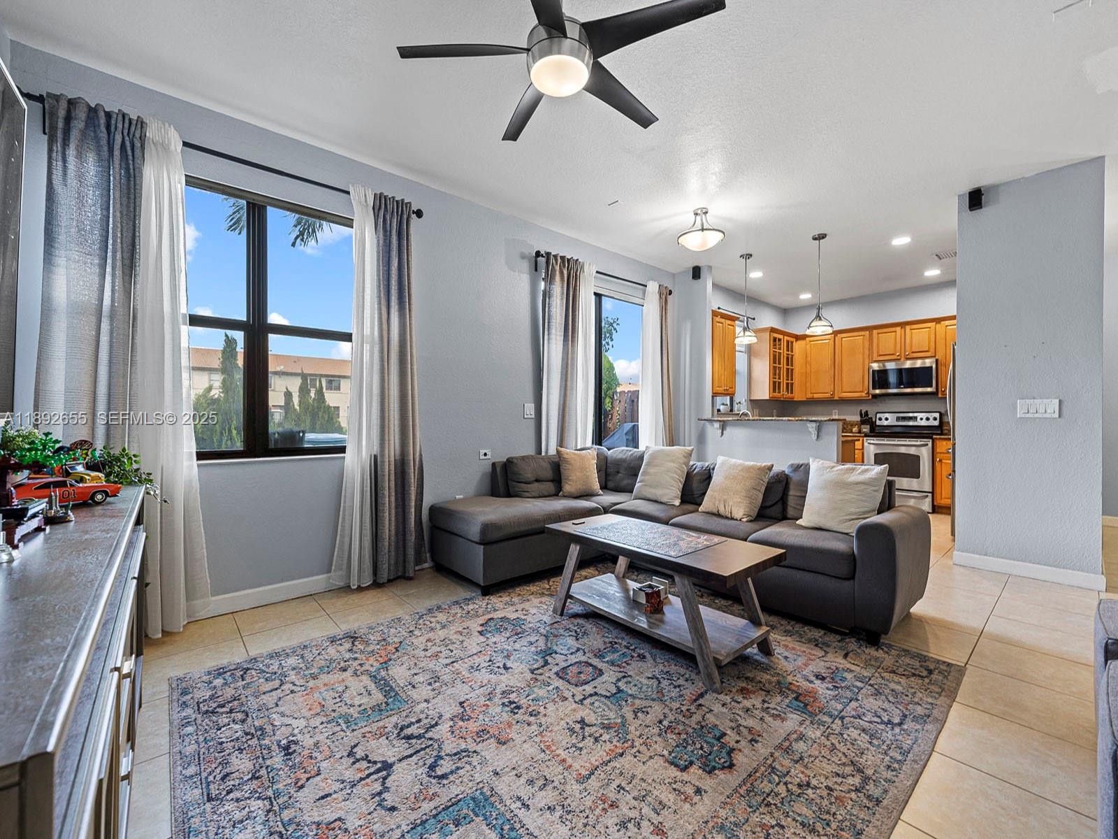 11279 Southwest 238th Street Homestead, FL 33032 - Photo 6 of 40 a living room with furniture and a window