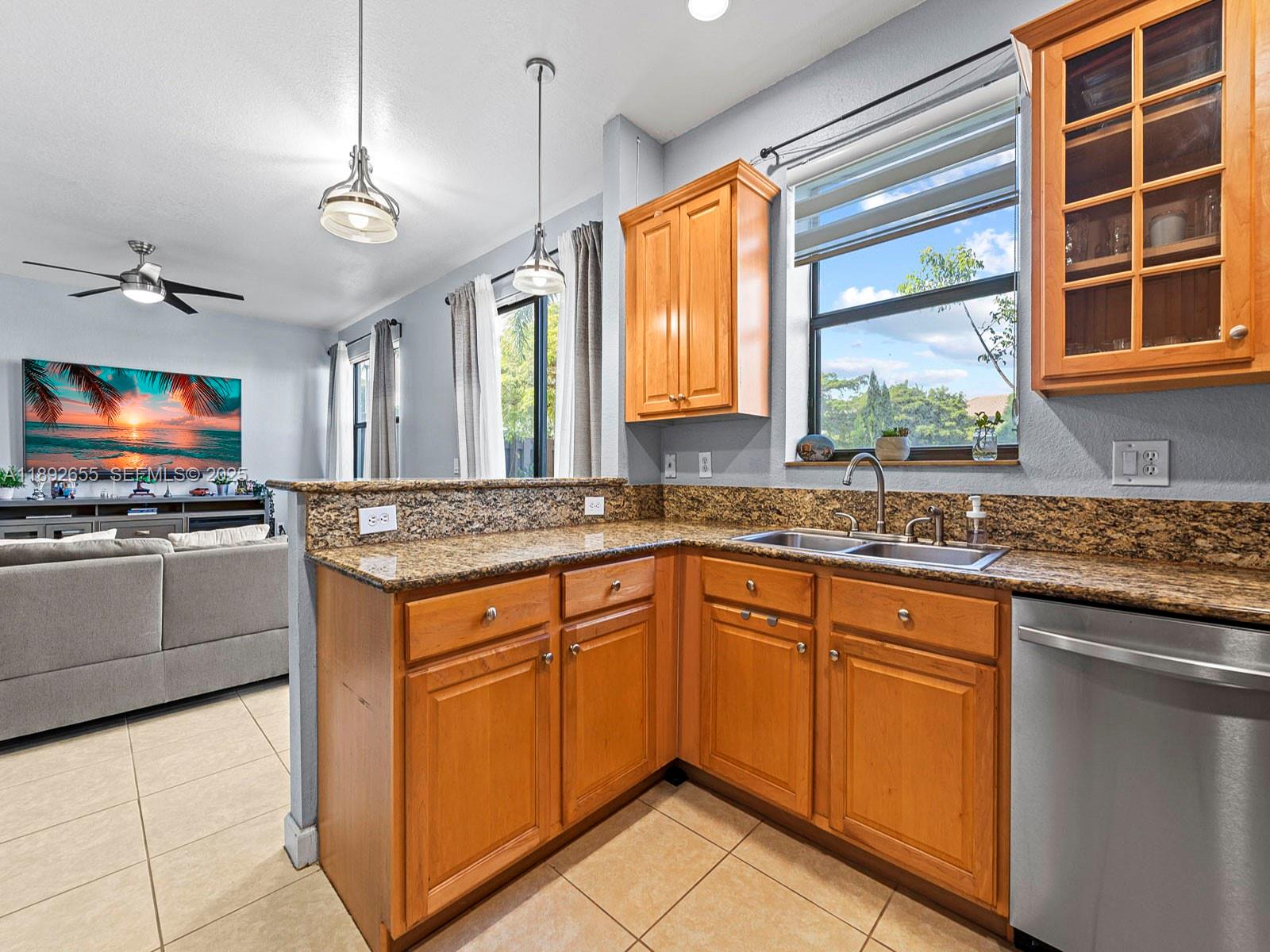 11279 Southwest 238th Street Homestead, FL 33032 - Photo 9 of 40 a kitchen with stainless steel appliances granite countertop a sink and a stove
