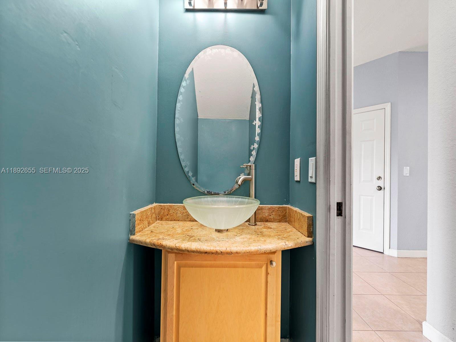 11279 Southwest 238th Street Homestead, FL 33032 - Photo 10 of 40 a bathroom with a sink and a mirror