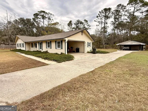 a front view of a house with a yard and trees