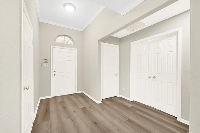 a view of empty room with wooden floor