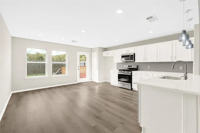 a view of kitchen with sink and microwave