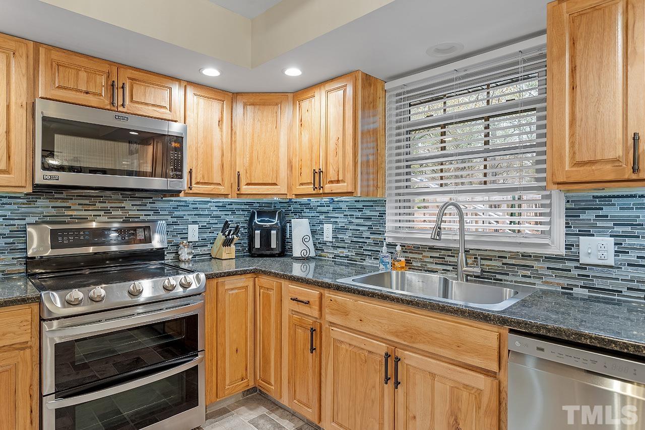 2683 C Rains Crossroads Road Selma, NC 27576 - Photo 11 of 30 a kitchen with stainless steel appliances a stove sink and microwave