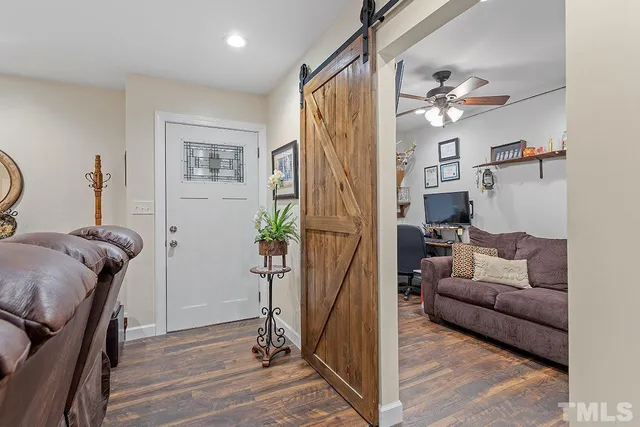 a living room with furniture a ceiling fan and a rug