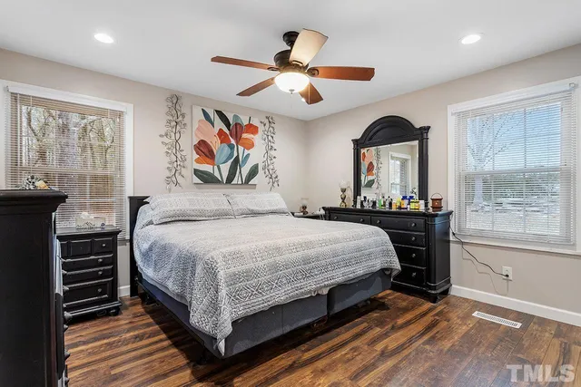 a bedroom with a large bed and a window