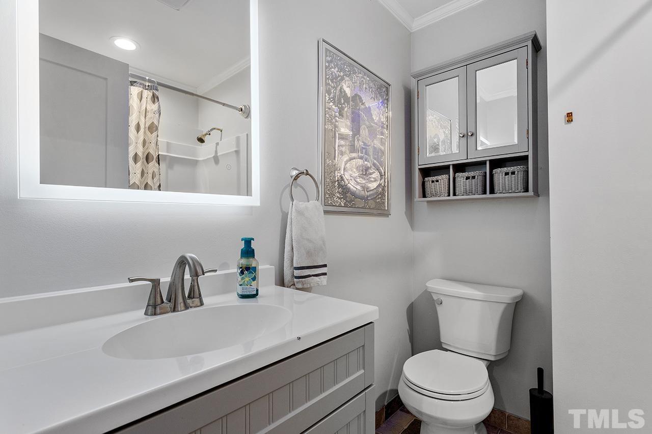 2683 C Rains Crossroads Road Selma, NC 27576 - Photo 21 of 30 a bathroom with a toilet sink and mirror