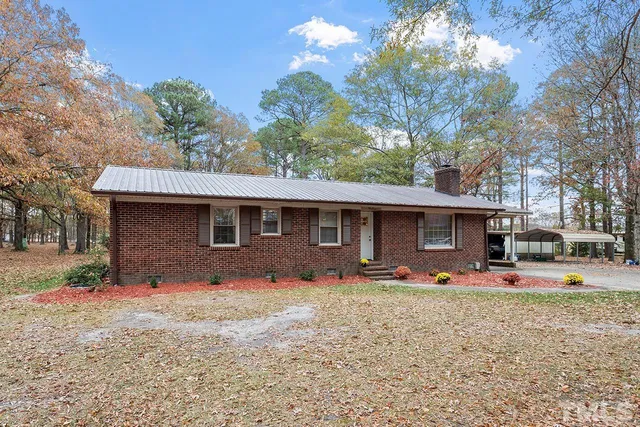 a front view of house with yard outdoor seating and green space