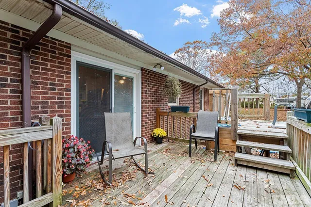 a view of a dinning tables and chairs in the patio in front of a house