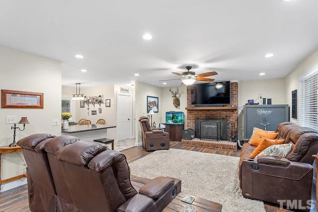 a living room with furniture a fireplace and a flat screen tv