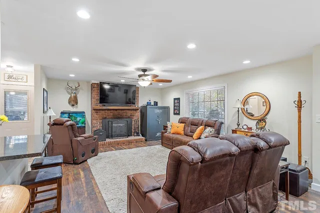 a living room with fireplace furniture and a flat screen tv