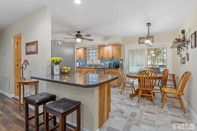 a dining room with furniture and a chandelier