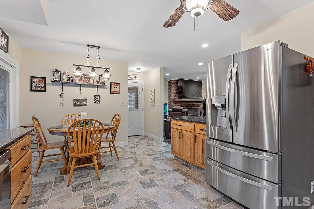 2683 C Rains Crossroads Road Selma, NC 27576 - Photo 8 of 30 a kitchen with stainless steel appliances granite countertop a dining table and chairs