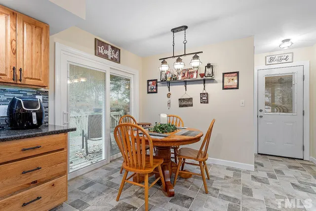 a dining room with furniture and window